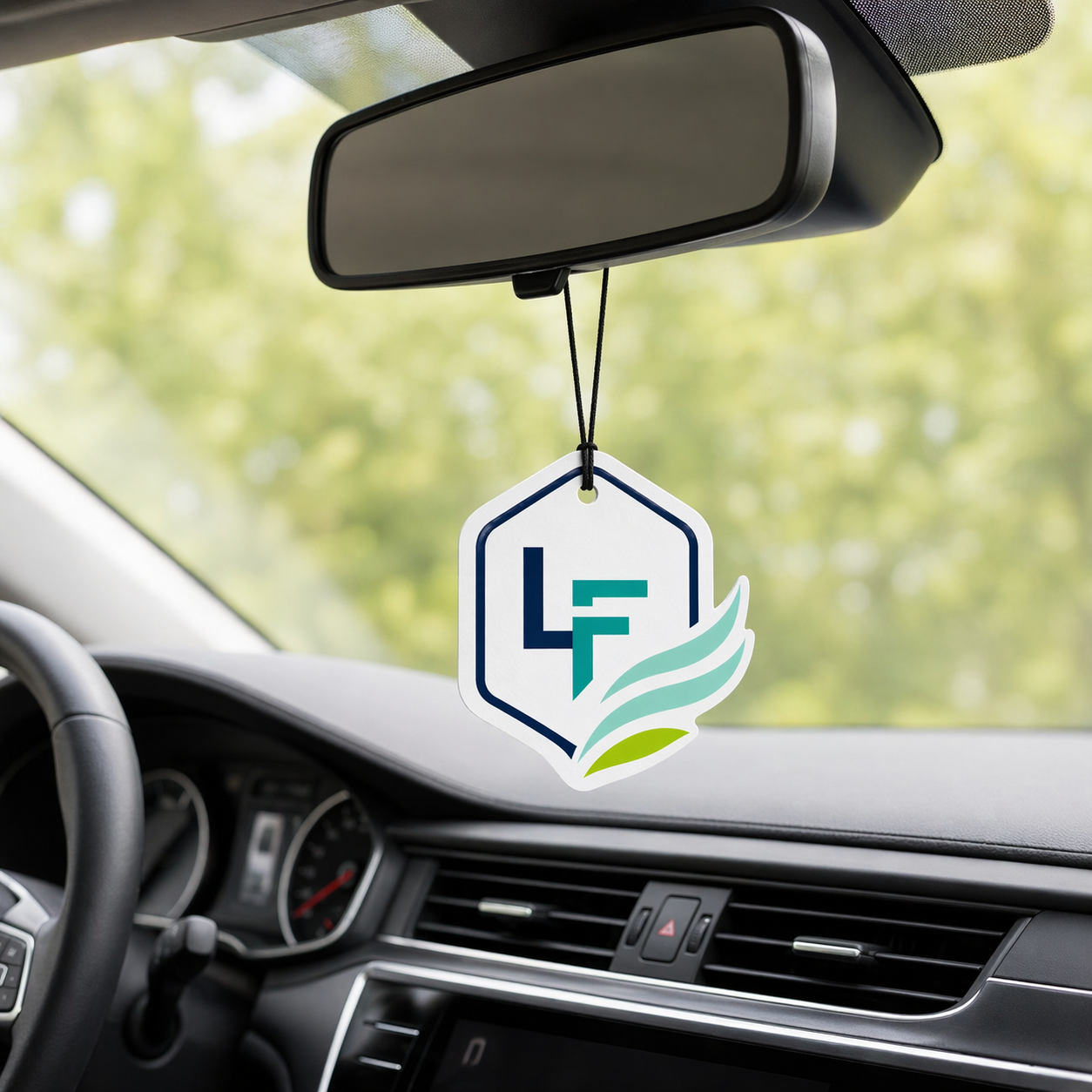 Custom branded LogoFresh air freshener hanging in a car